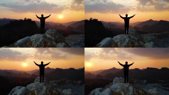 成功登顶成功人士站在山顶眺望拥抱蓝天登山