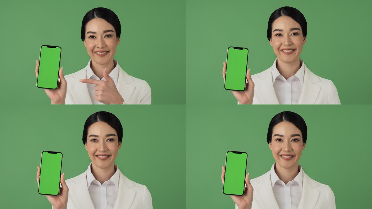 绿色屏幕背景下的美丽商业女性肖像。她微笑着向镜头展示她的智能手机。