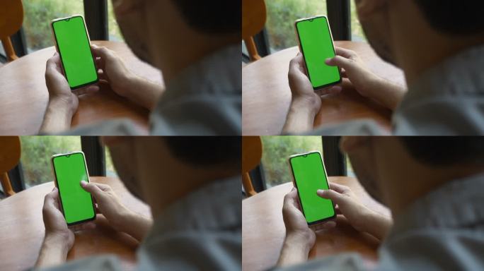 特写手持绿色屏幕智能手机的男子。手中拿着色卡的智能手机