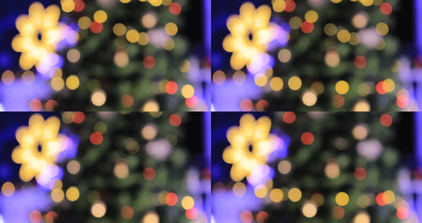 圣诞树上模糊的灯光庆祝，新年快乐的彩色背景。