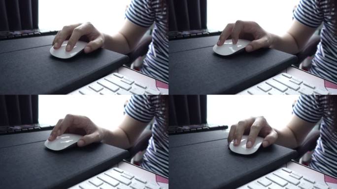 女孩使用电脑鼠标。
