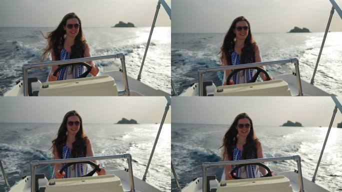 可爱而快乐的女孩驾驶快艇在梦中度假。享受风在头发和微笑