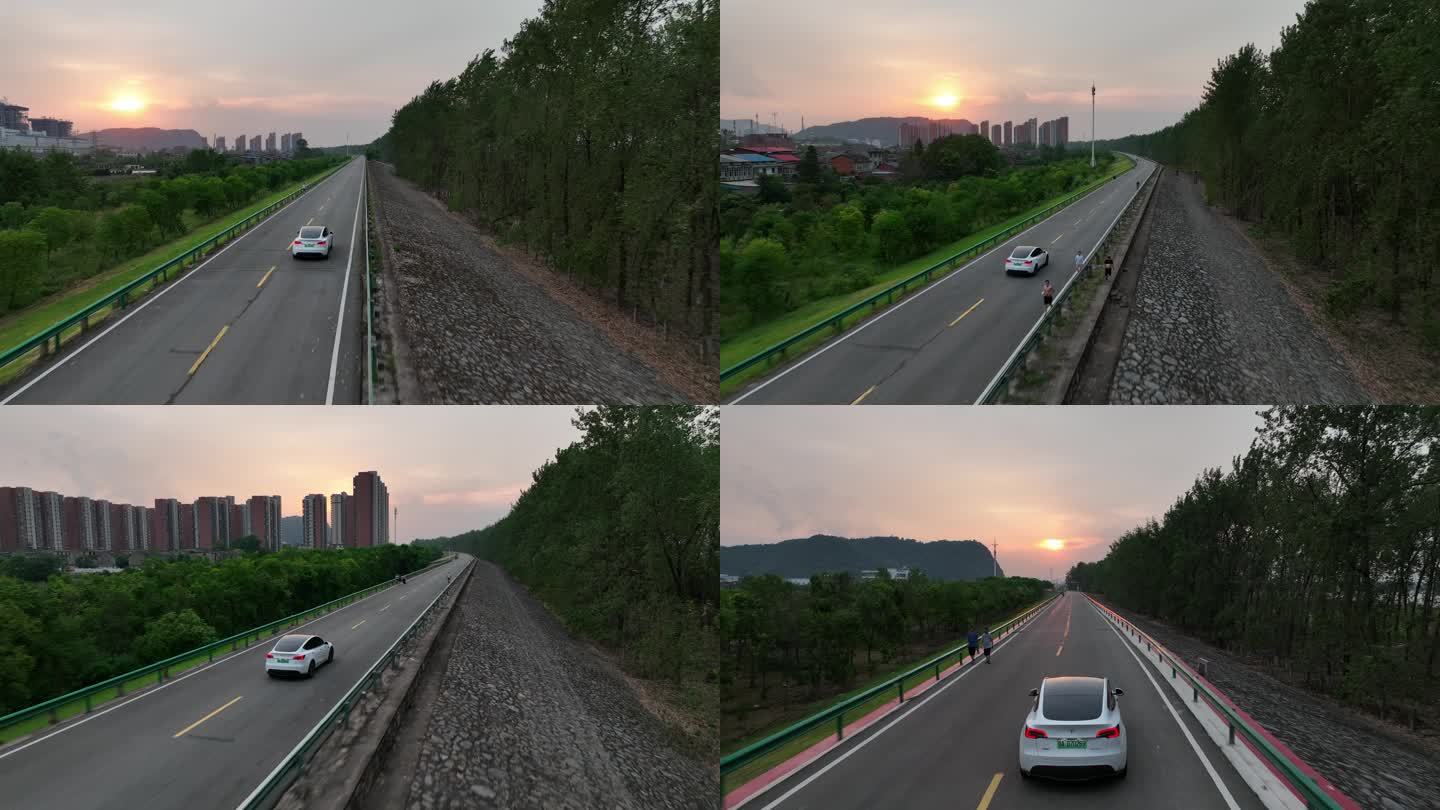 夕阳下特斯拉modely驰骋在长江大堤上