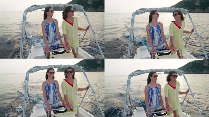 放松的女性朋友享受梦幻假期的快艇之旅。聊天和微笑拥抱