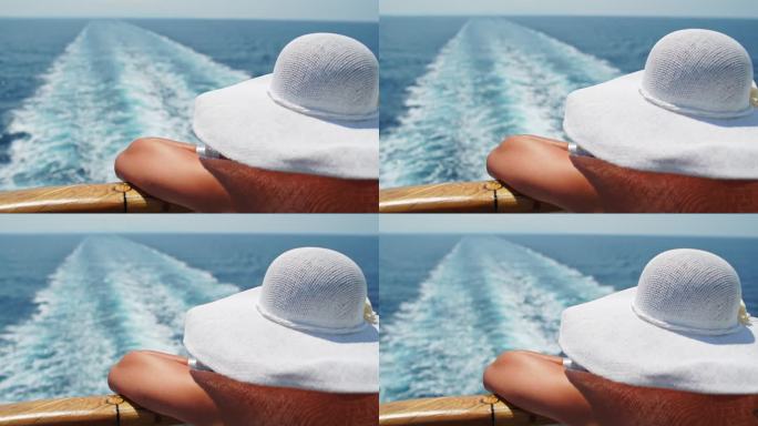 戴帽子的女人在游轮上欣赏风景