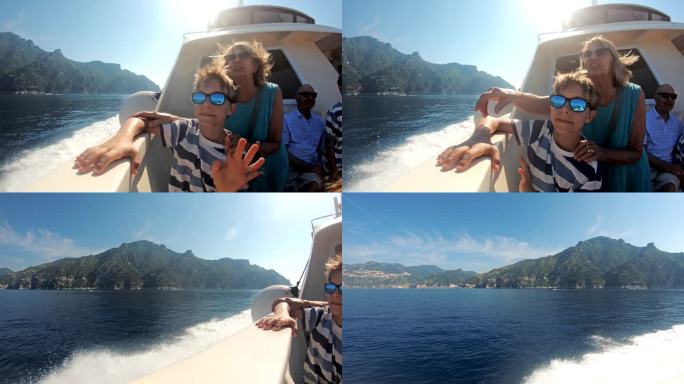 意大利阿马尔菲海岸附近，一位年长的妇女带着孙子乘船旅行