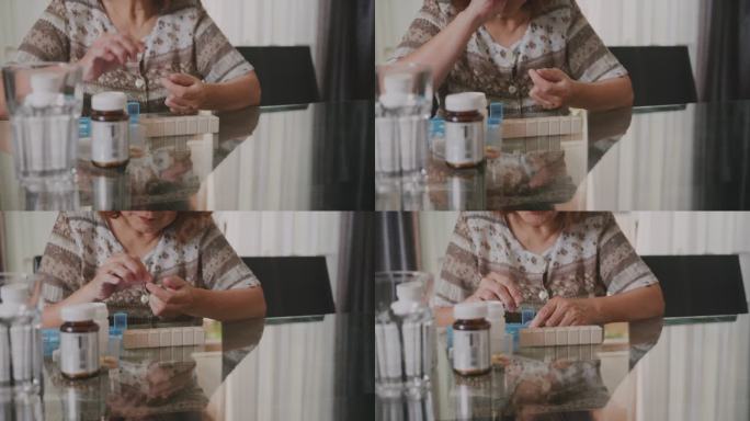 亚洲老年女性老年人将药物放入每日药丸整理器中并关闭盖子。