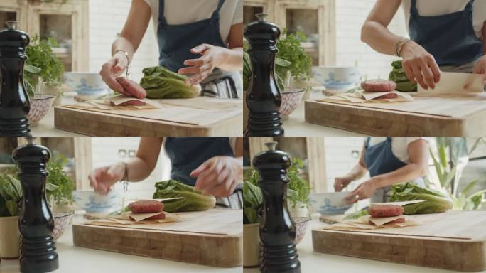 一位女士在厨房里为汉堡肉饼准备碎牛肉