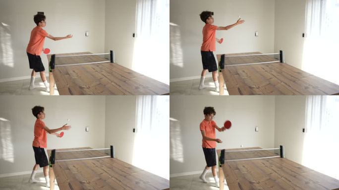 小男孩在家里室内打乒乓球。慢动作