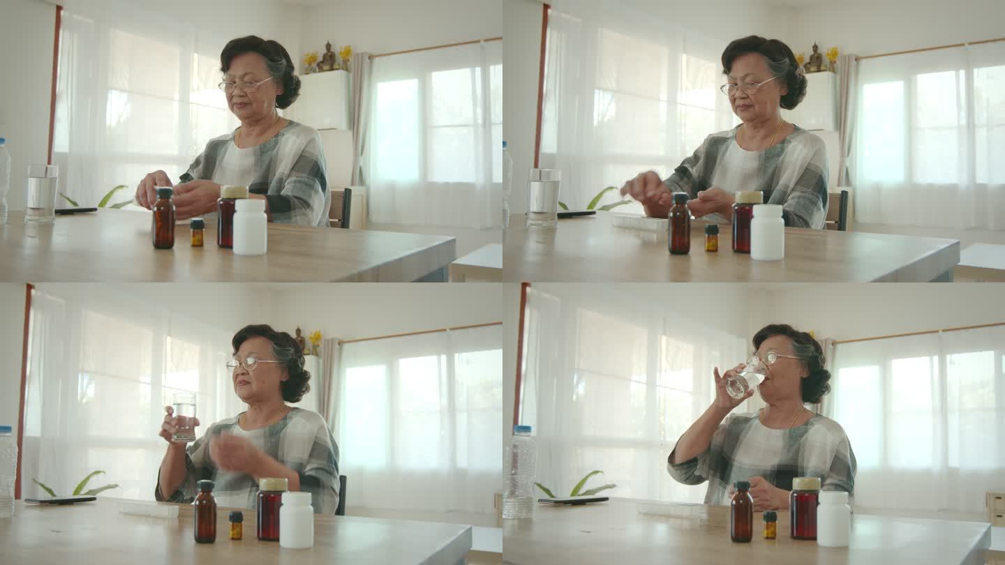 一位老年妇女从每日药片整理盒中取出药片，并用一口水将其吞下。