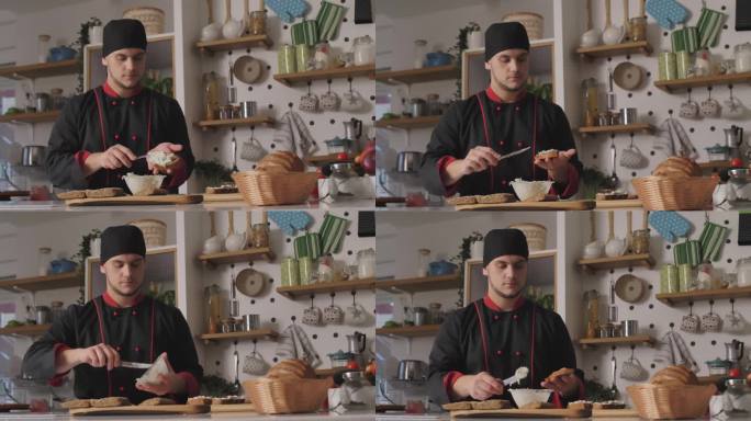 复制厨师在黑麦面包片上涂抹奶油奶酪和香葱混合物的空间照片