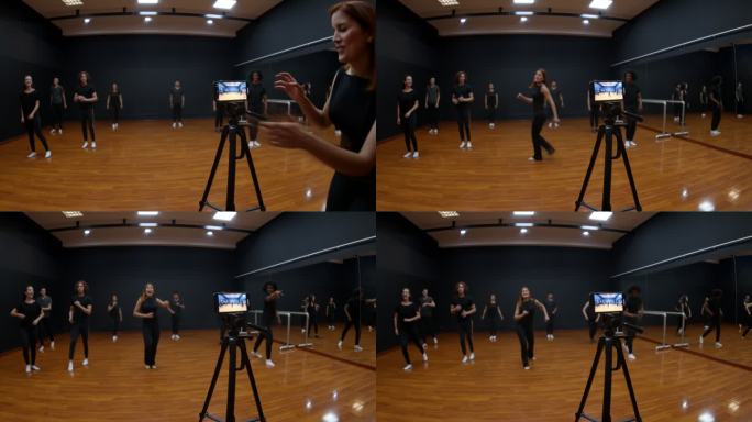 一位拉丁美洲教师用三脚架和智能手机与学生一起录制舞蹈节目