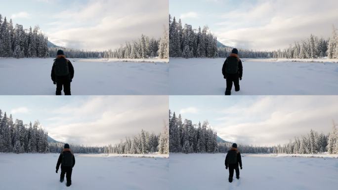 4K冬天冰天雪地中行走的背包人背影