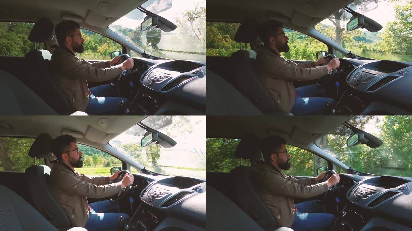 驾驶员一个英俊的年轻人驾驶着一辆汽车，车上安装了GoPro摄像机。日落时分开车。