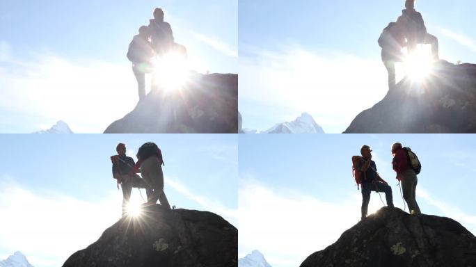 登山夫妇到岩石顶峰