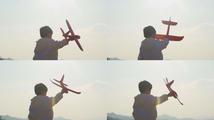 小男孩拿着飞机模型玩耍欢乐童年放飞梦想