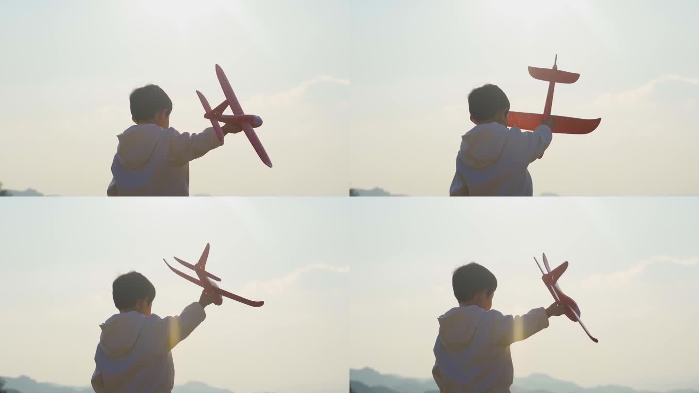 小男孩拿着飞机模型玩耍欢乐童年放飞梦想