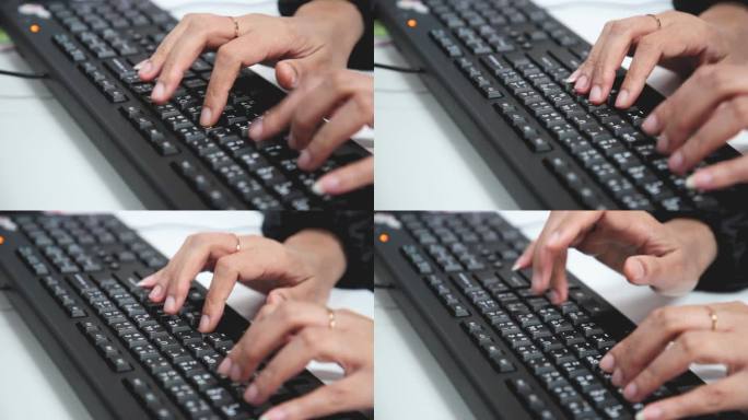 女性用手在键盘上打字。