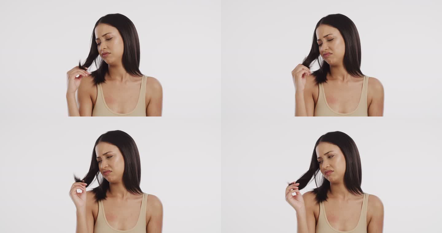 4k视频画面显示，一名女子看着自己被劈开的头发，脸上露出不悦的表情