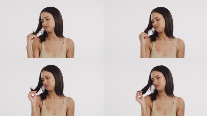 4k视频画面显示，一名女子看着自己被劈开的头发，脸上露出不悦的表情