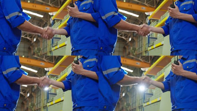在工厂仓库工作成功后，专业的男性行业工人相互握手。有吸引力的男性工业工程师在制造工厂处理订单和产品后