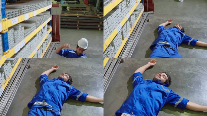 年轻的白人男性工业工人在制造厂工作时摔倒在地。有魅力的男性工业工厂工程师在工厂仓库发生事故时戴着头盔