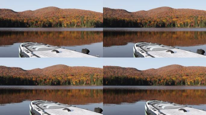 秋天，加拿大魁北克省特伦布兰特山国家公园，Lac Monroe湖上的一个直立式桨板上的POV。