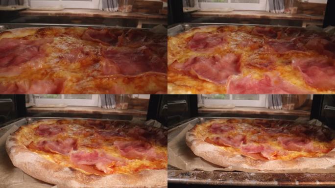 在家庭厨房用火腿和新鲜罗勒制作披萨