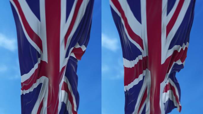 垂直英国国旗在4K分辨率的蓝天下缓缓飘扬