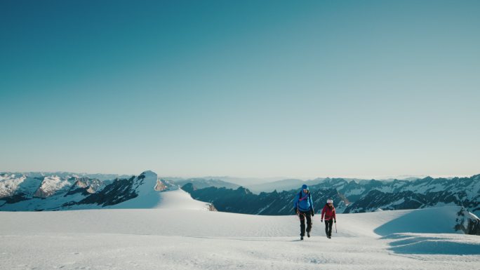 山区徒步旅行冰山雪地行走男女队员