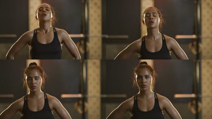 4k视频画面，一位年轻的运动女性在健身房锻炼时屏住呼吸