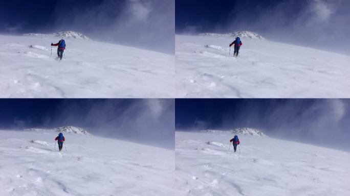 高姿态的暴风雪中的女登山者