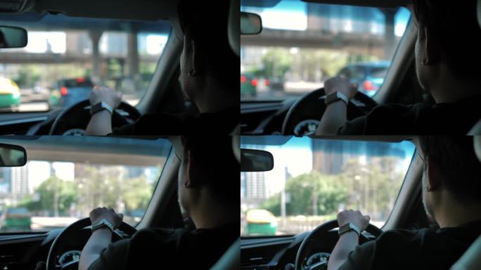 亚洲男子在城市里开车