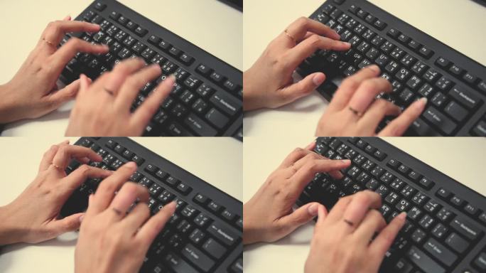 女性用手在键盘上打字。