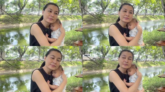 年轻的亚洲母亲和婴儿接吻
