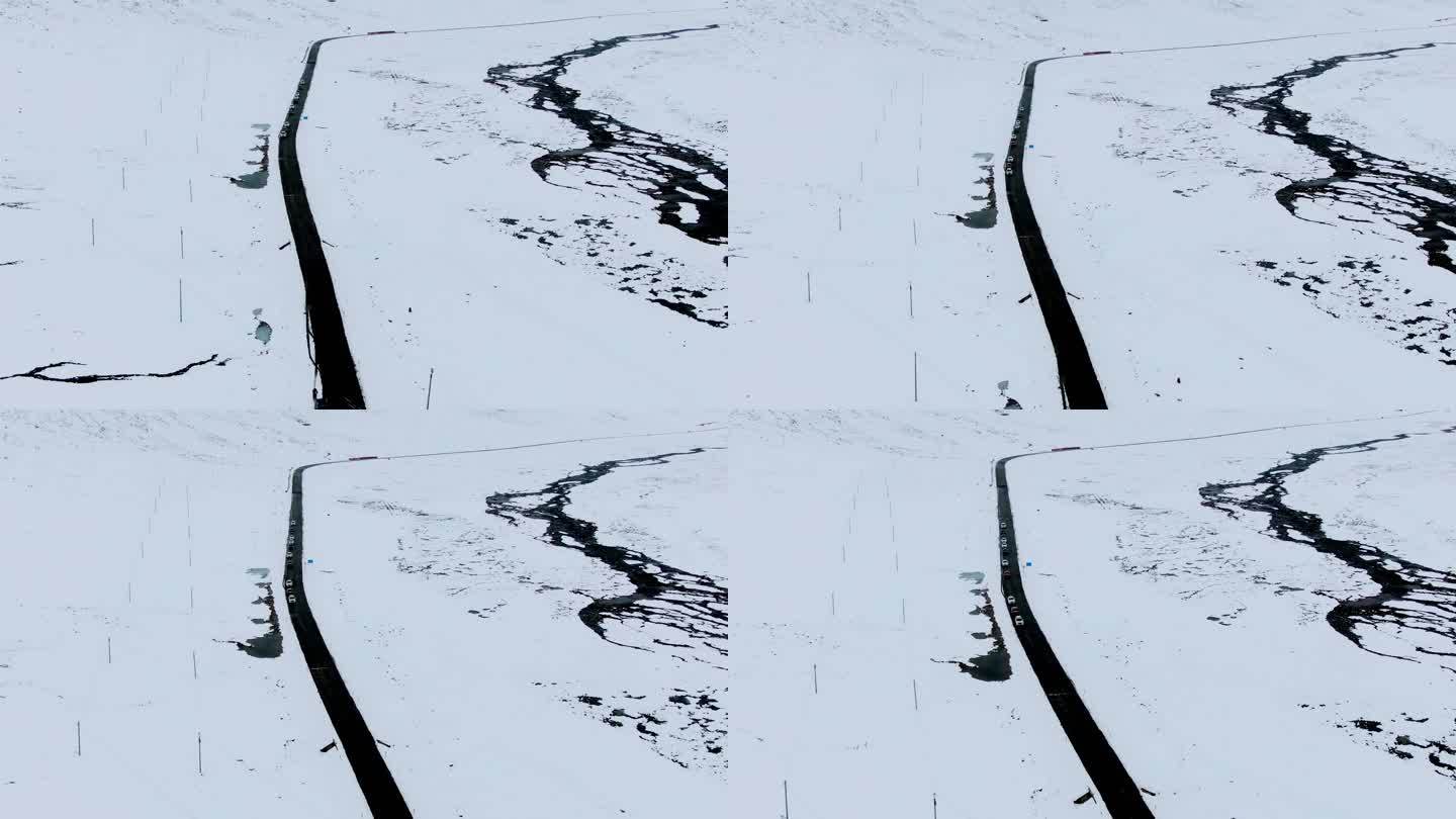 航拍车队穿过雪地航拍俯拍鸟瞰俯瞰黑色和白