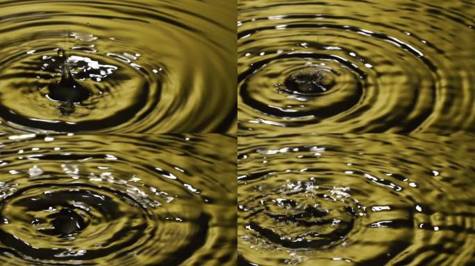 慢动作：许多水滴入黄色水中。
