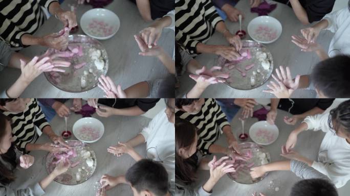 亚洲华人家庭正在制作汤圆，为中国新年做准备。农历新年、冬季节日用红白相间的中国传统食品粽子。