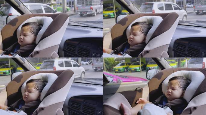亚洲男婴睡在汽车座椅上，曼谷的城市生活。