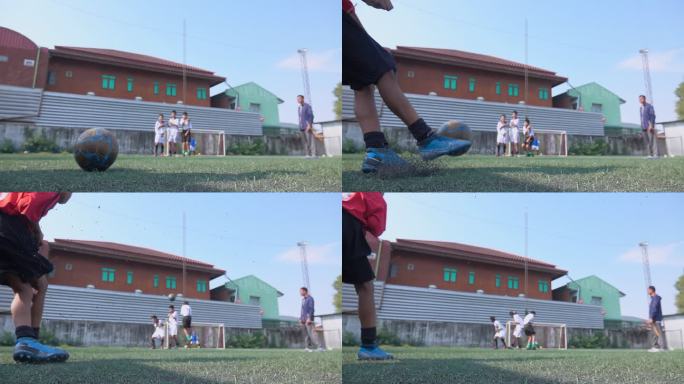 男孩足球运动员将球踢向球门慢动作