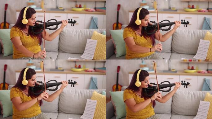 年轻的小提琴家在家练习演奏