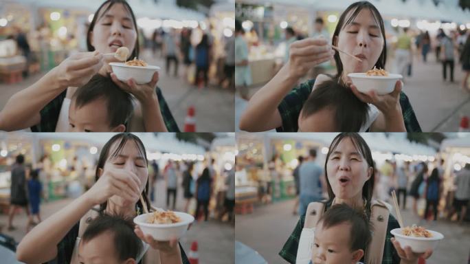 年轻的母亲在泰国享受街头美食