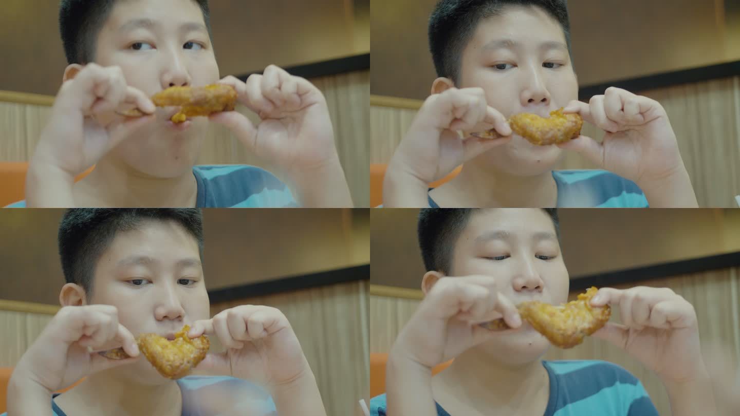 亚洲男孩在快餐店吃炸鸡，带着家庭、生活方式的理念。