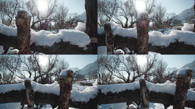 北方村庄木栅栏上的积雪