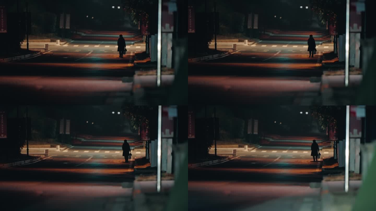 一个人孤独的行走在夜晚的马路街道长焦拍摄