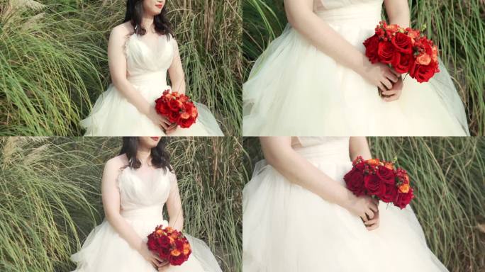 穿着婚纱的姑娘手里的红色玫瑰花束