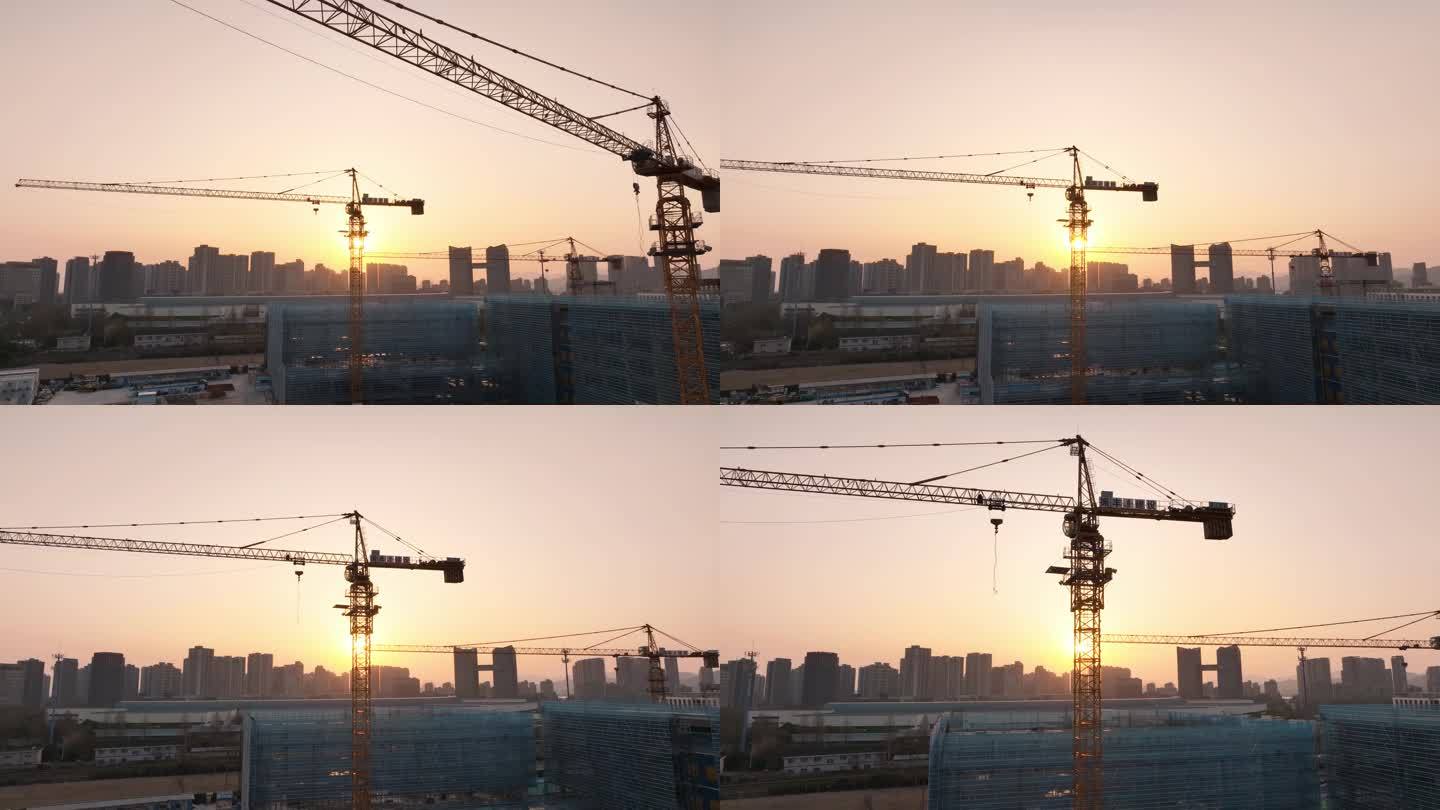 航拍夕阳下建筑工地施工塔吊起重机