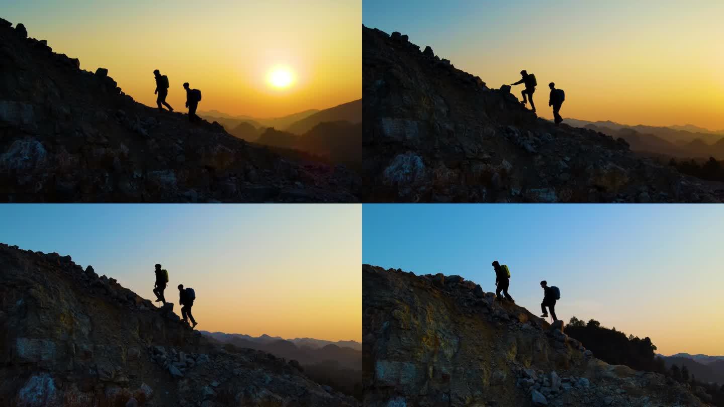 团队登山逆光爬山攀登顶峰背包客徒步旅行者