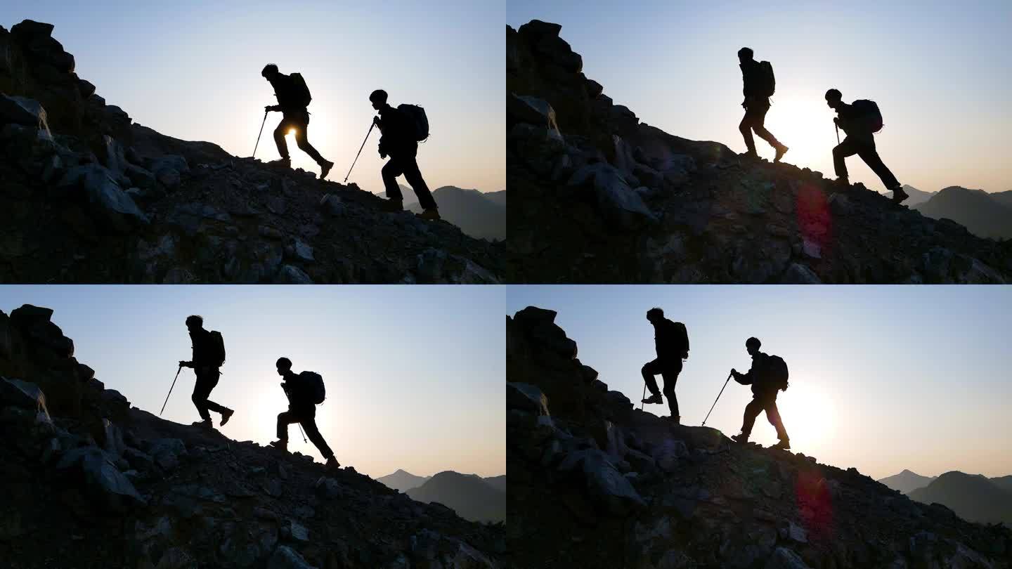 逆光登山剪影攀登顶峰户外探险徒步旅行爬山