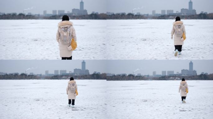 女孩走在结冰的江面上背影